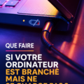 Femme utilisant un ordinateur portable branché sans charger, perplexe face à un écran vide.