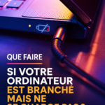 Femme utilisant un ordinateur portable branché sans charger, perplexe face à un écran vide.